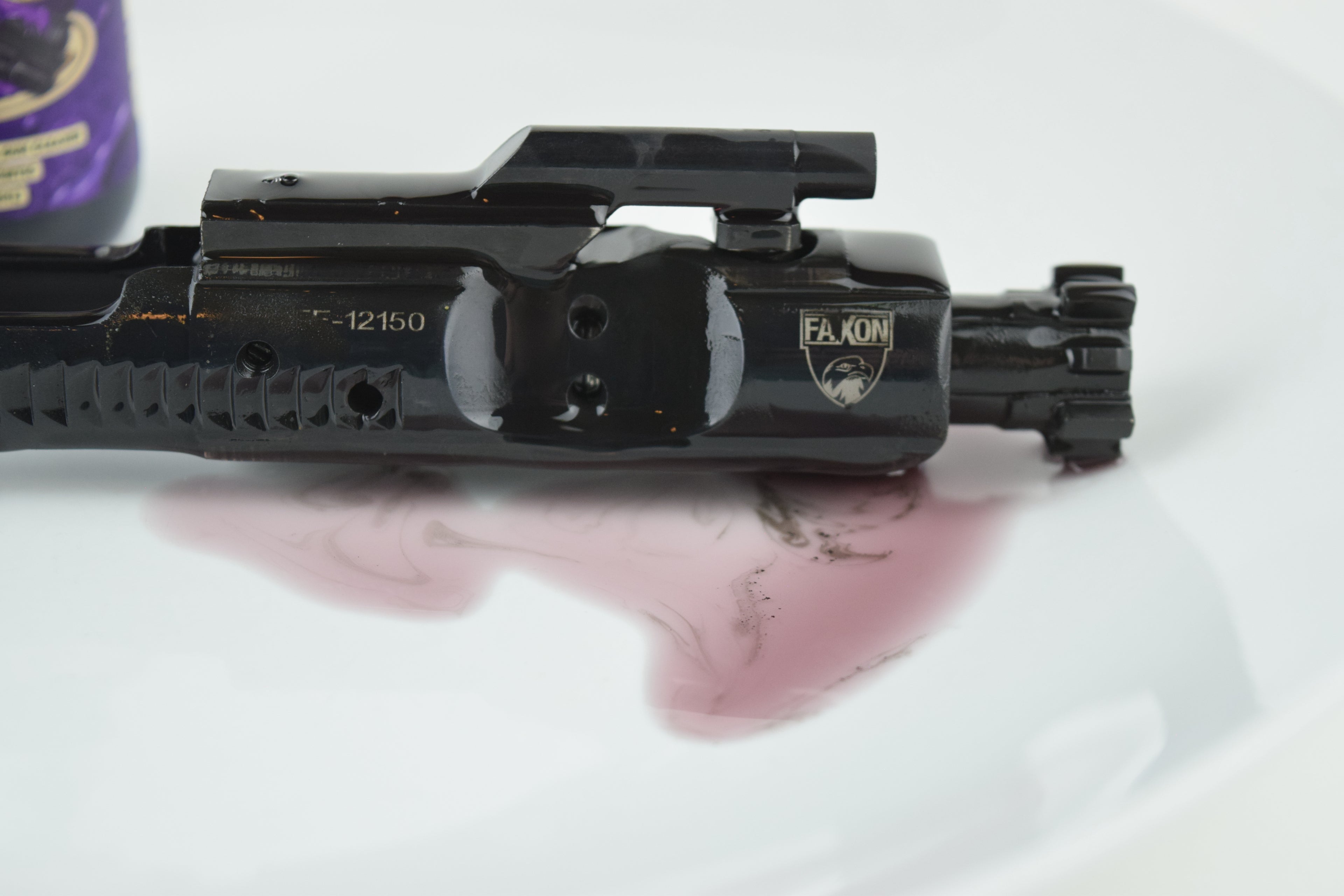 Carbon cleanse on a faxon AR-15 bolt carrier. Showing the cleaner working to break down carbon and keeping the debris in suspension 