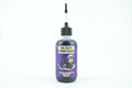 A bottle of Gun Jelly's Carbon Cleanse with a purple label and a black cap with a long metal applicator needle, set against a plain white background.