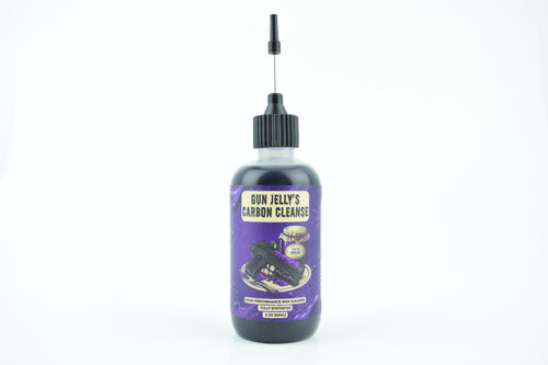 A bottle of Gun Jelly's Carbon Cleanse with a purple label and a black cap with a long metal applicator needle, set against a plain white background.